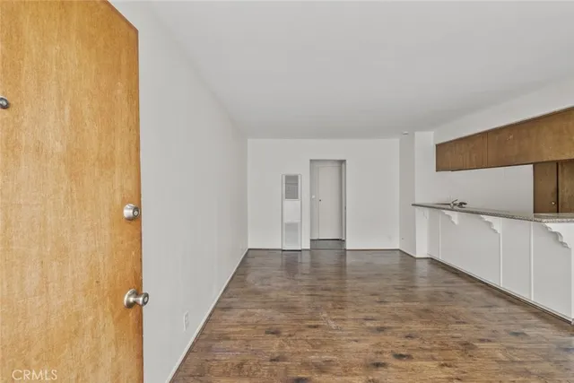a view of a kitchen with a sink and cabinets