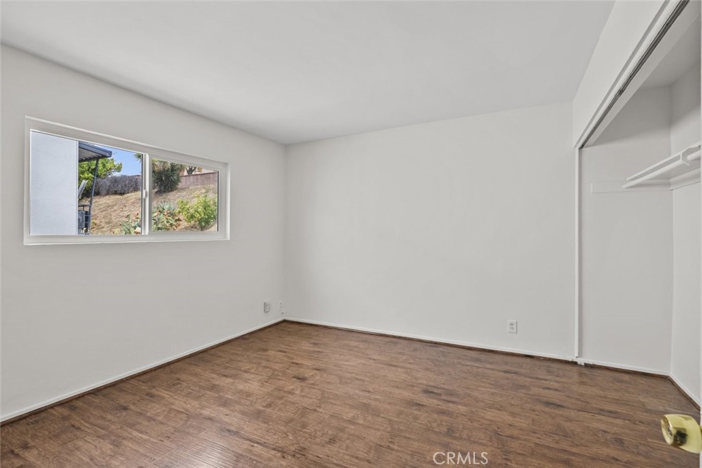1601 College View Drive, Unit 12 Monterey Park, CA 91754 - Photo 24 of 27 an empty room with wooden floor and window