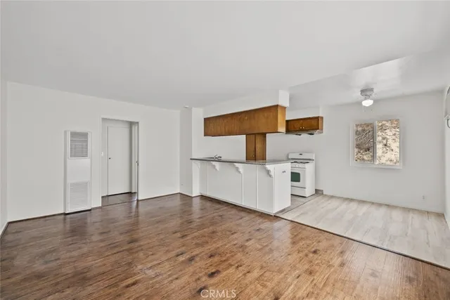 a view of a kitchen with wooden floor