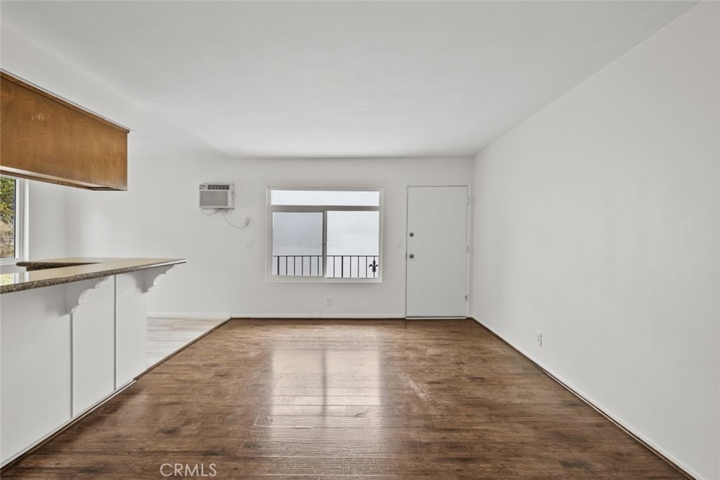1601 College View Drive, Unit 12 Monterey Park, CA 91754 - Photo 6 of 27 a view of an empty room with a window and wooden floor
