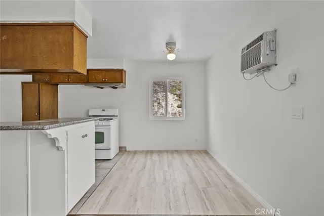 a view of a kitchen with wooden floor and a sink