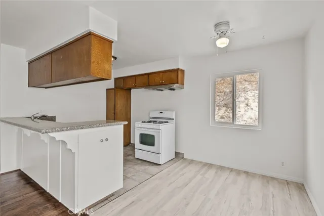 a kitchen with a sink cabinets and a wooden floor