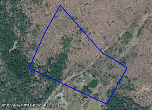 a spacious bedroom with a bed and a flat screen tv