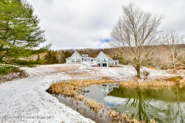 a bathroom with a granite countertop toilet a sink and a mirror