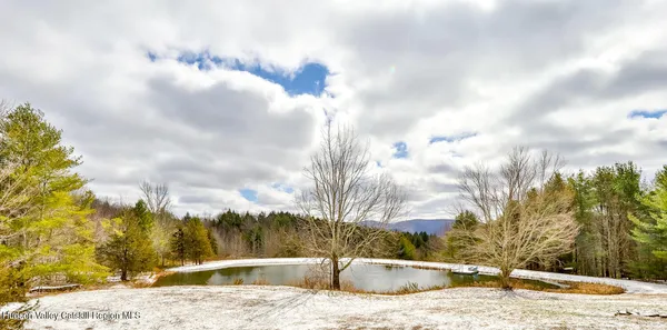 a living room with furniture a flat screen tv and a window