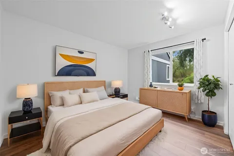 a bedroom with a bed and a potted plant