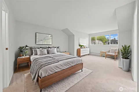 a spacious bedroom with a bed and a couch