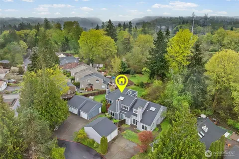an aerial view of a house with a yard and outdoor seating