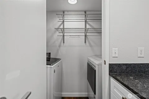 a kitchen with a refrigerator a washer and dryer