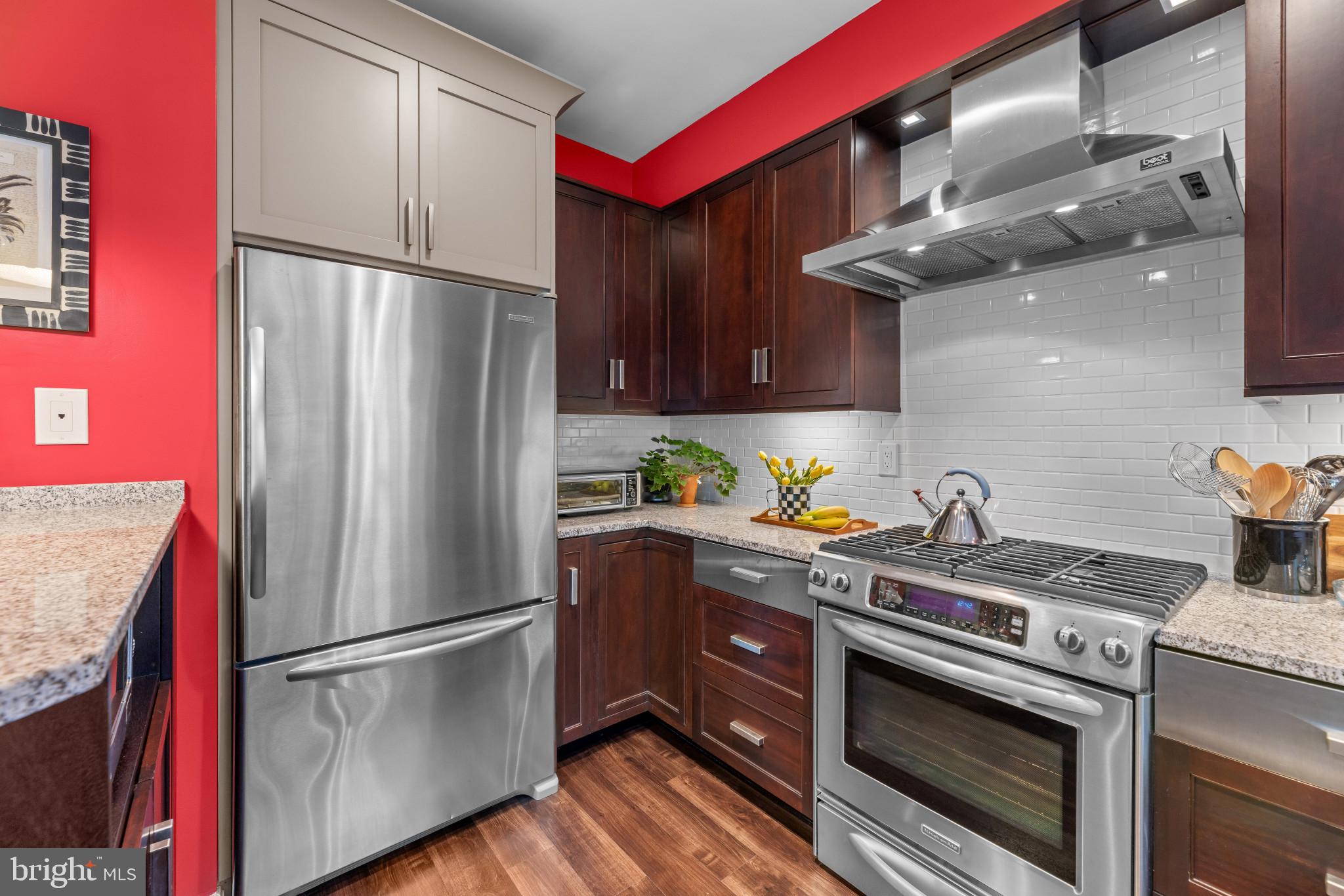 21980 Box Car Square Sterling, VA 20166 - Photo 7 of 38 a kitchen with stainless steel appliances granite countertop a refrigerator a sink and a stove