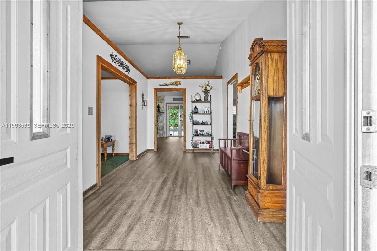 17490 Southwest 288th Street Homestead, FL 33030 - Photo 28 of 80 a view of a hallway view with wooden floor and staircase