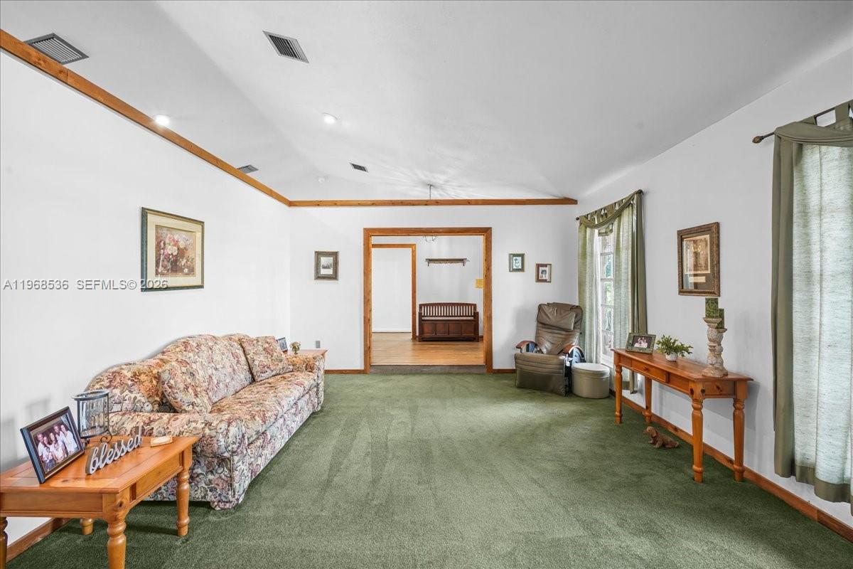17490 Southwest 288th Street Homestead, FL 33030 - Photo 30 of 80 a living room with furniture and a flat screen tv