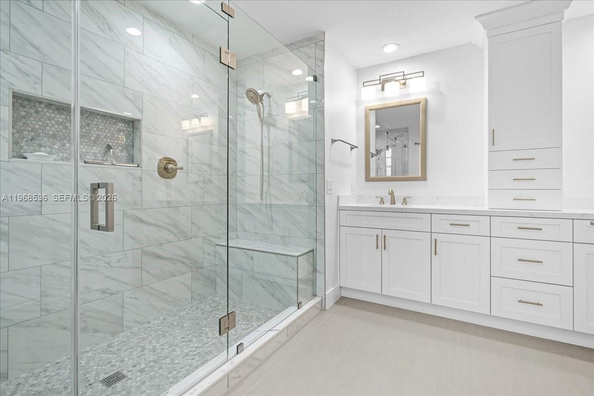 17490 Southwest 288th Street Homestead, FL 33030 - Photo 44 of 80 a bathroom with a shower sink and mirror