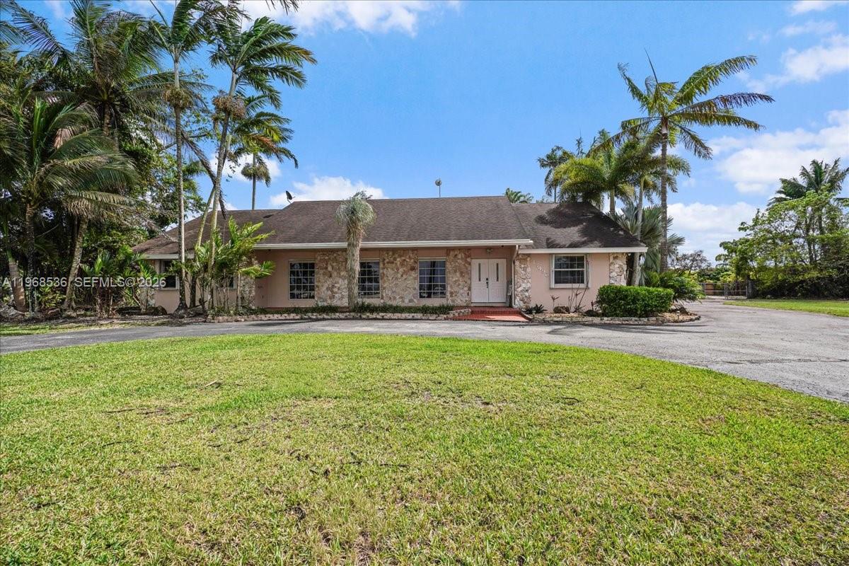 17490 Southwest 288th Street Homestead, FL 33030 - Photo 55 of 80 a front view of house with yard and outdoor seating