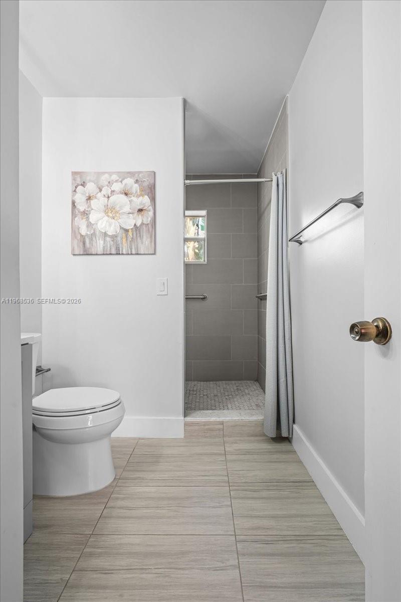 17490 Southwest 288th Street Homestead, FL 33030 - Photo 59 of 80 a bathroom with a toilet and a shower