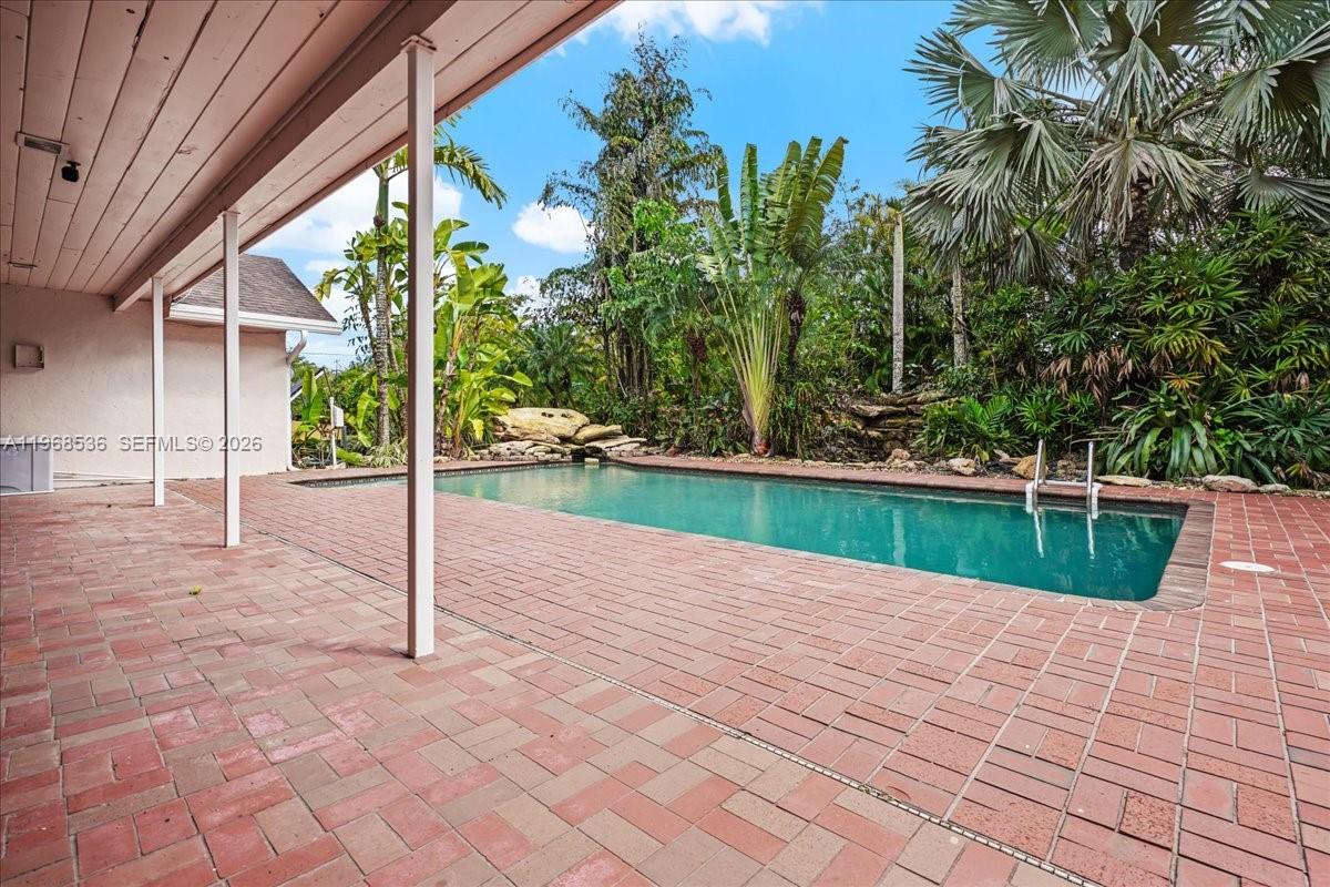 17490 Southwest 288th Street Homestead, FL 33030 - Photo 75 of 80 a view of swimming pool with a patio