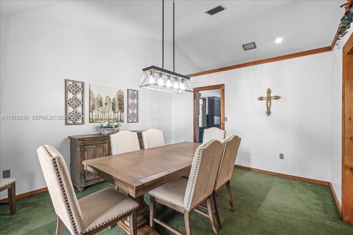 17490 Southwest 288th Street Homestead, FL 33030 - Photo 8 of 80 a view of a dining room with furniture window and wooden floor