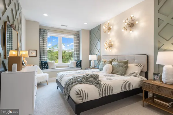 a spacious bedroom with a large bed and a large window
