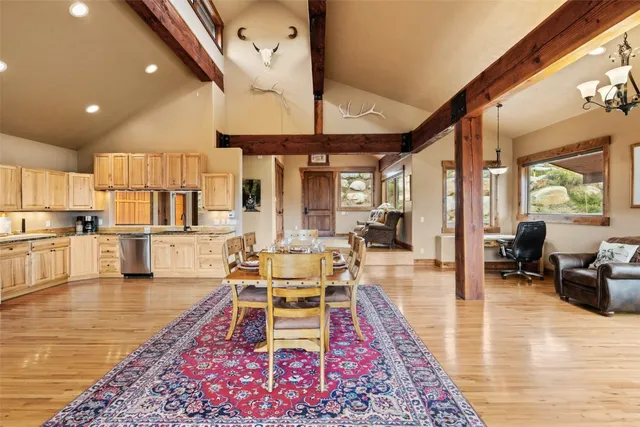 a living room with dining room and wooden floor