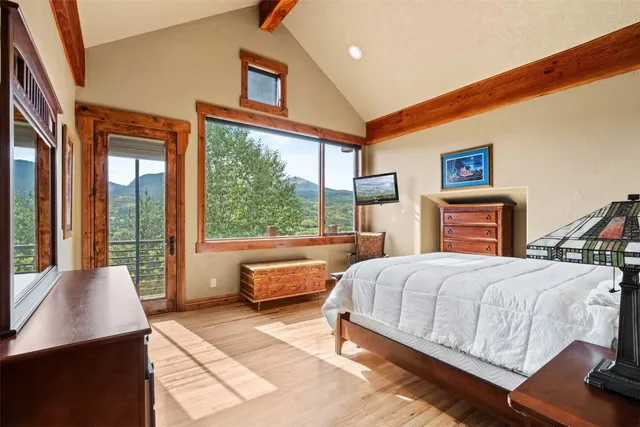 a bedroom with a large bed and a window