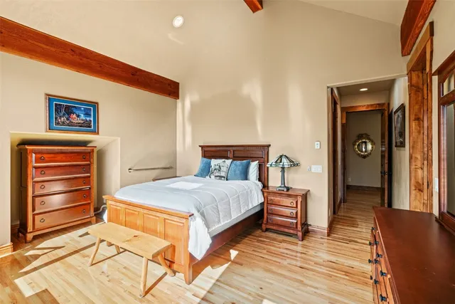 a bedroom with a bed and wooden floor