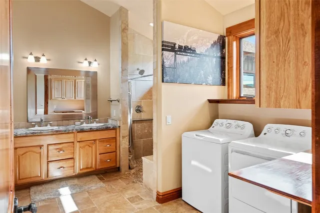 a kitchen with a refrigerator sink and cabinets