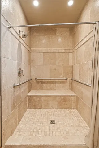 a bathroom with a bathtub and shower