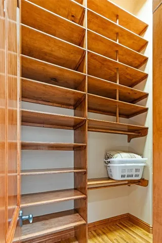 a view of a bedroom with furniture and wooden floor