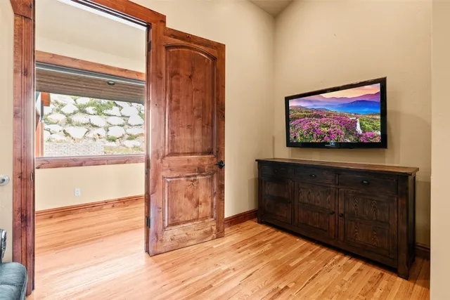 a living room with a couch and a wooden floor