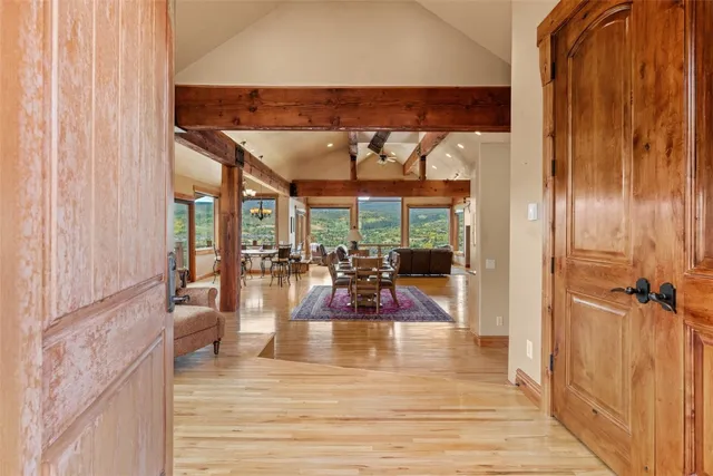a view of a living room and dining room with wooden floor