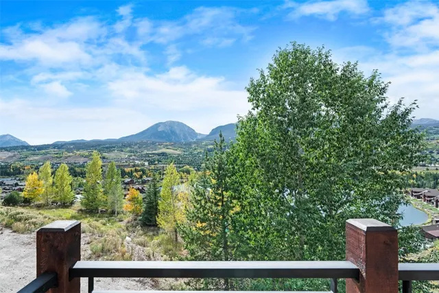 a view of a balcony with wooden floor and fence