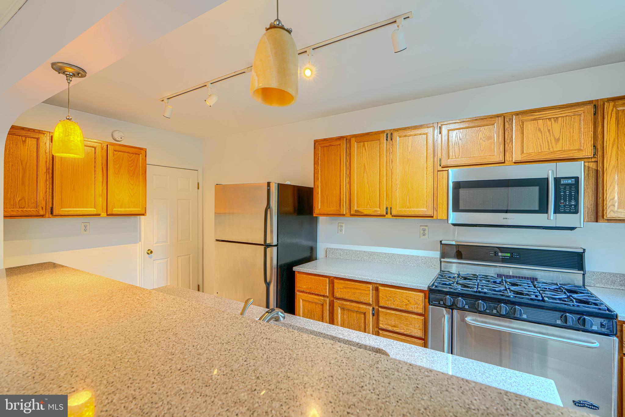372 Old Trail Baltimore, MD 21212 - Photo 10 of 46 a kitchen with stainless steel appliances granite countertop a refrigerator and microwave
