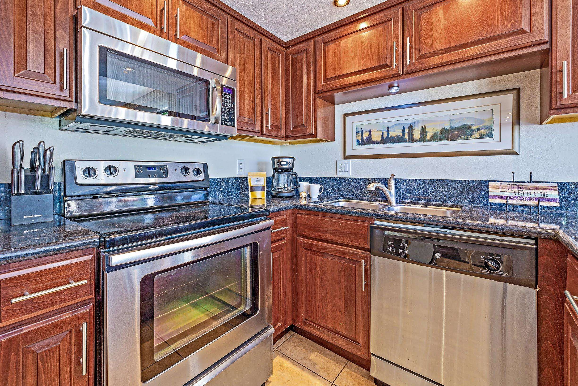 3543 Lower Honoapiilani Road, Unit H201 Lahaina, HI 96761 - Photo 11 of 31 a kitchen with stainless steel appliances granite countertop a stove microwave and sink