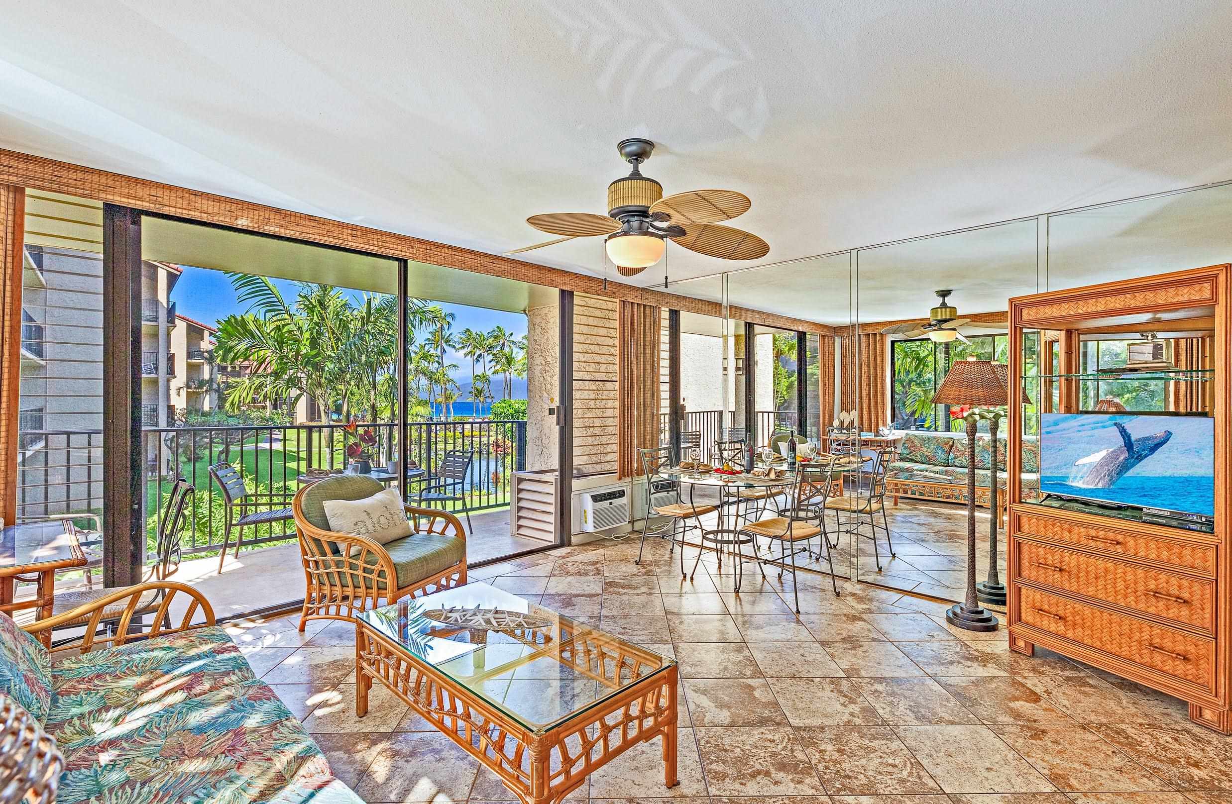 3543 Lower Honoapiilani Road, Unit H201 Lahaina, HI 96761 - Photo 14 of 31 a living room filled with furniture and a chandelier