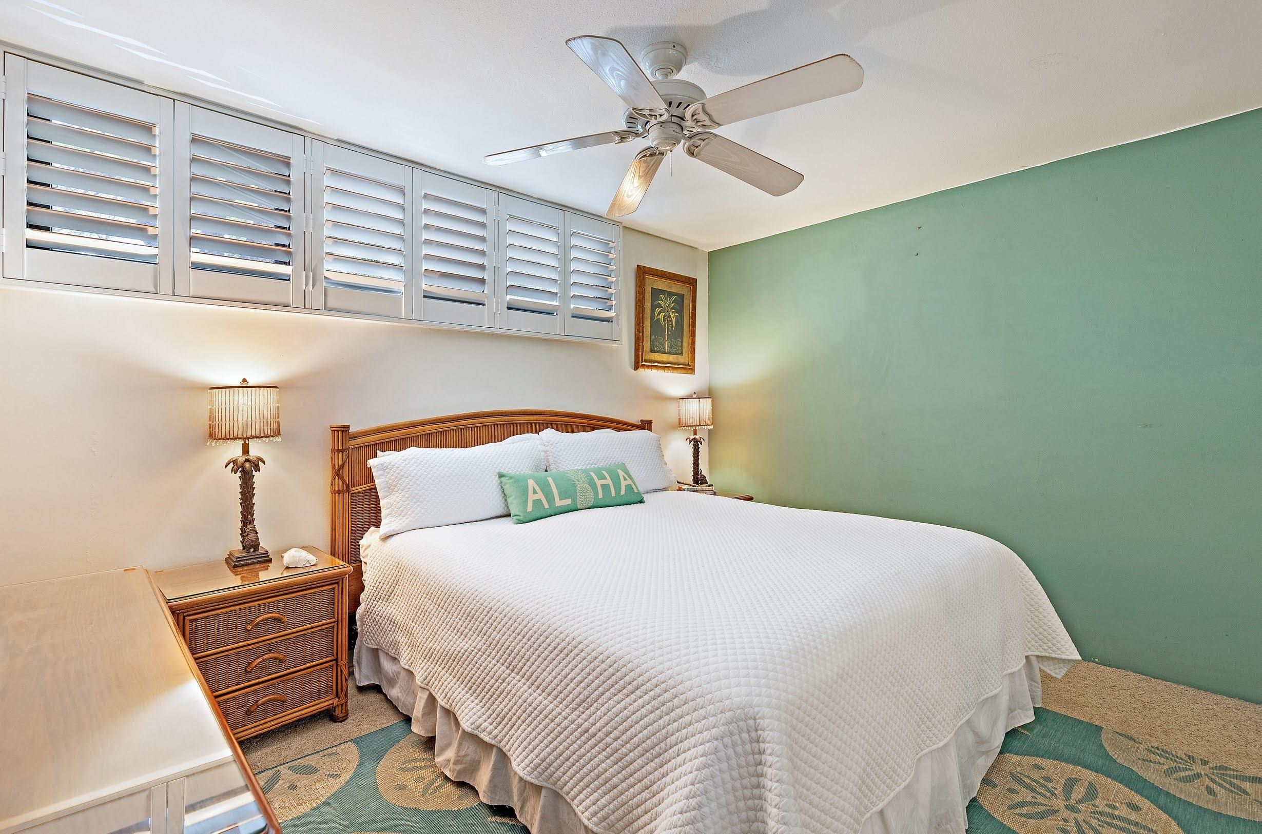 3543 Lower Honoapiilani Road, Unit H201 Lahaina, HI 96761 - Photo 20 of 31 a bedroom with a bed and a chandelier