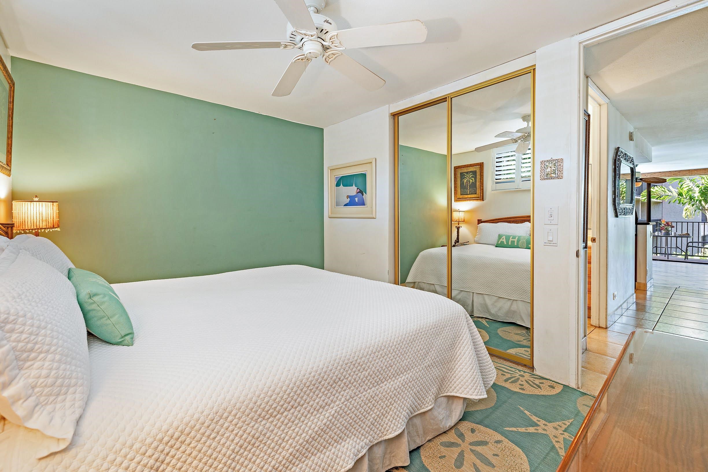 3543 Lower Honoapiilani Road, Unit H201 Lahaina, HI 96761 - Photo 21 of 31 a bedroom with a bed and wooden floor