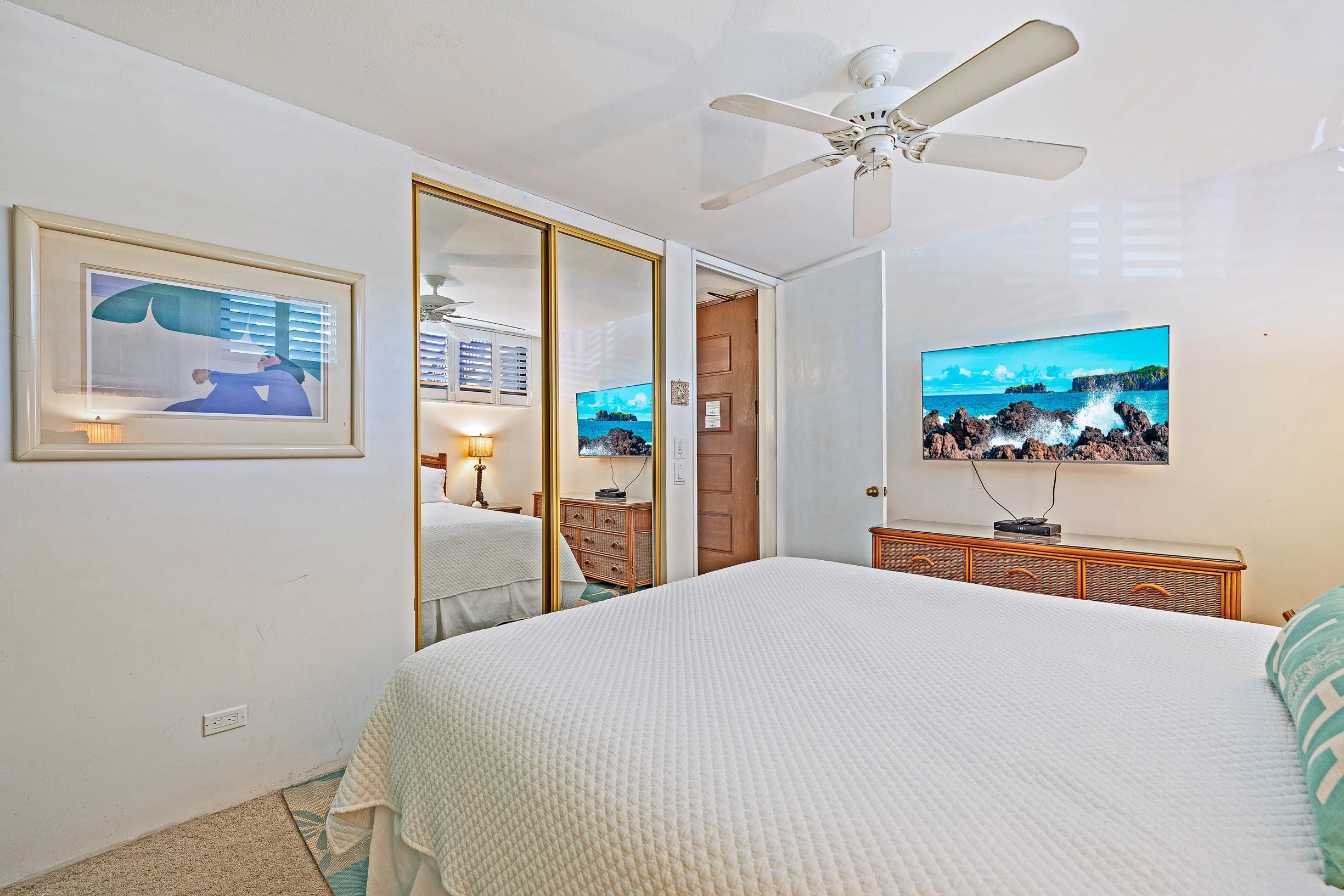 3543 Lower Honoapiilani Road, Unit H201 Lahaina, HI 96761 - Photo 22 of 31 a bedroom with a large bed and a chandelier