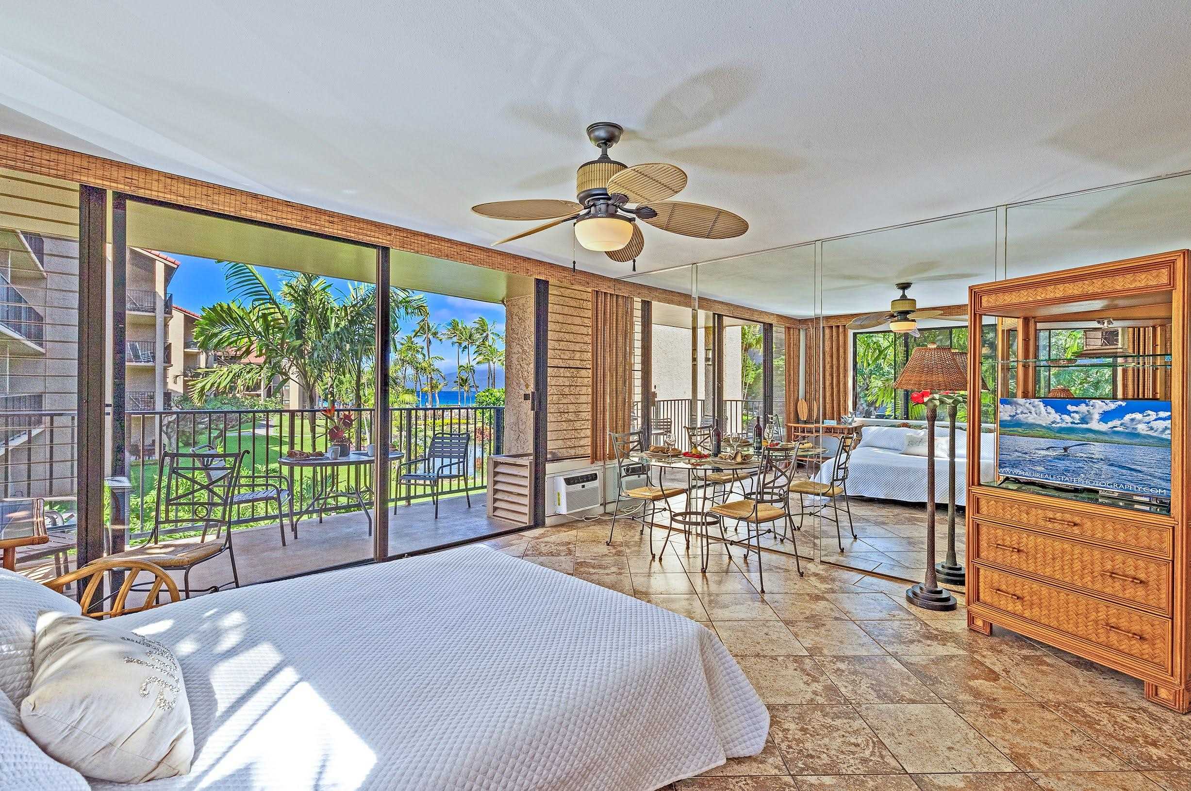 3543 Lower Honoapiilani Road, Unit H201 Lahaina, HI 96761 - Photo 7 of 31 a very nice looking room with a large window and dining table