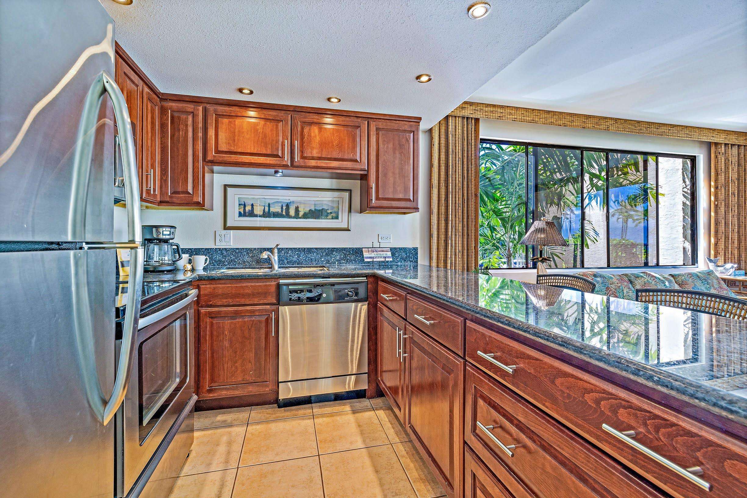3543 Lower Honoapiilani Road, Unit H201 Lahaina, HI 96761 - Photo 10 of 31 a kitchen with stainless steel appliances granite countertop a refrigerator and a sink