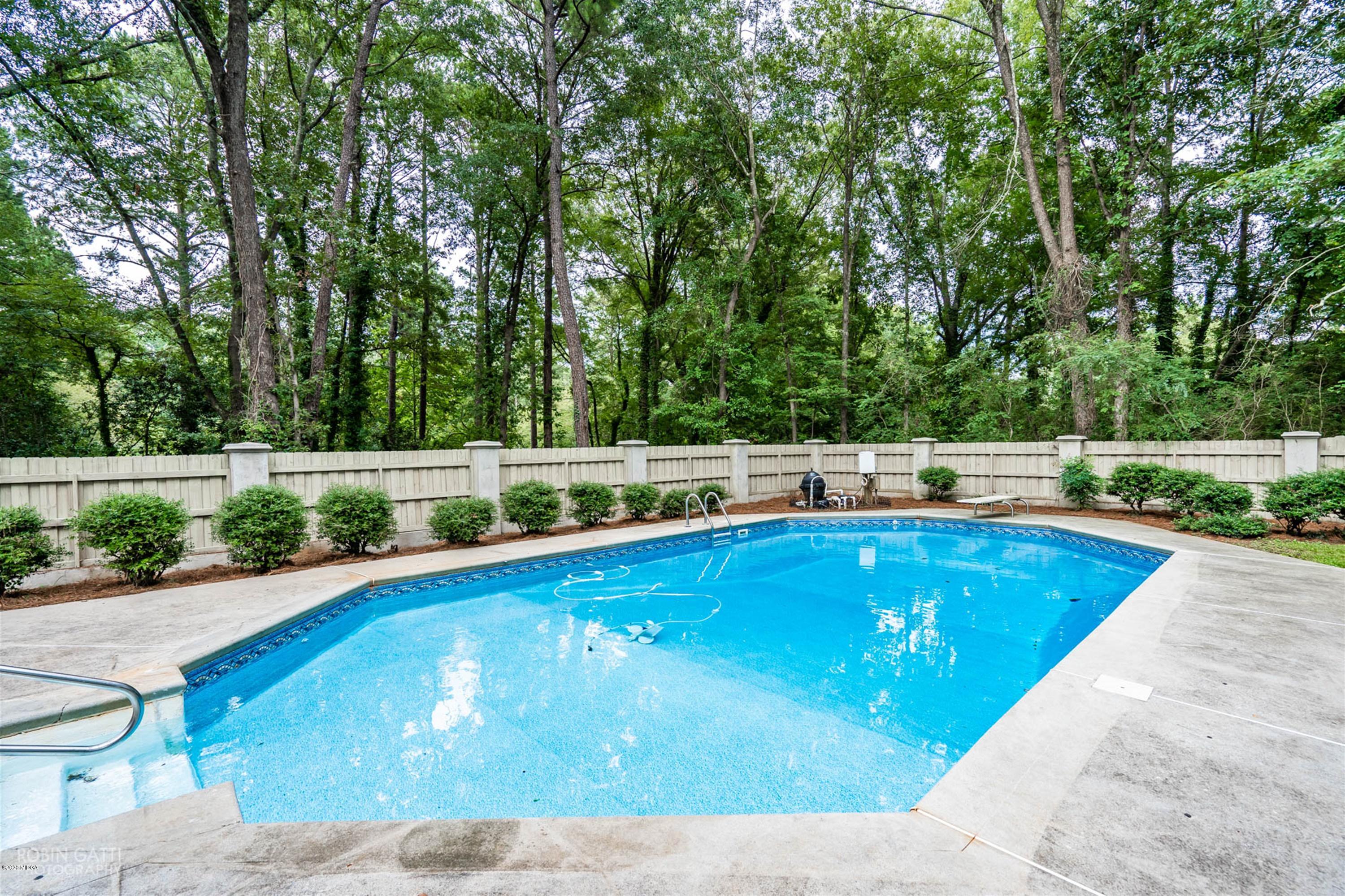 5435 Riverside Drive Macon, GA 31210 - Photo 8 of 34 a view of a swimming pool with a yard