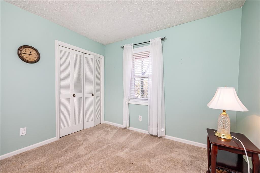 7750 Roswell Road, Unit 9G Sandy Springs, GA 30350 - Photo 16 of 18 a view of an empty room with a chandelier fan
