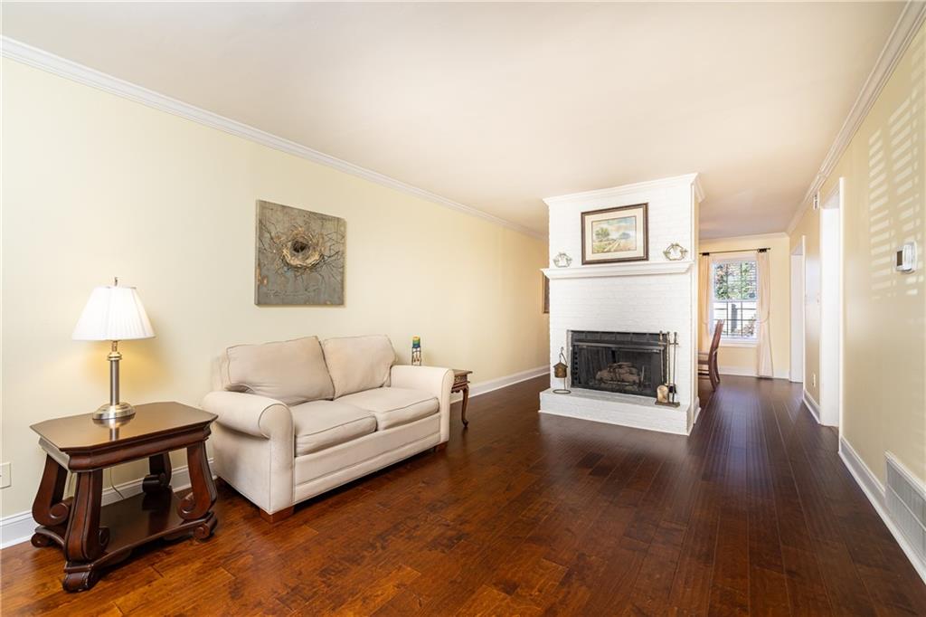 7750 Roswell Road, Unit 9G Sandy Springs, GA 30350 - Photo 3 of 18 a living room with furniture and a fireplace