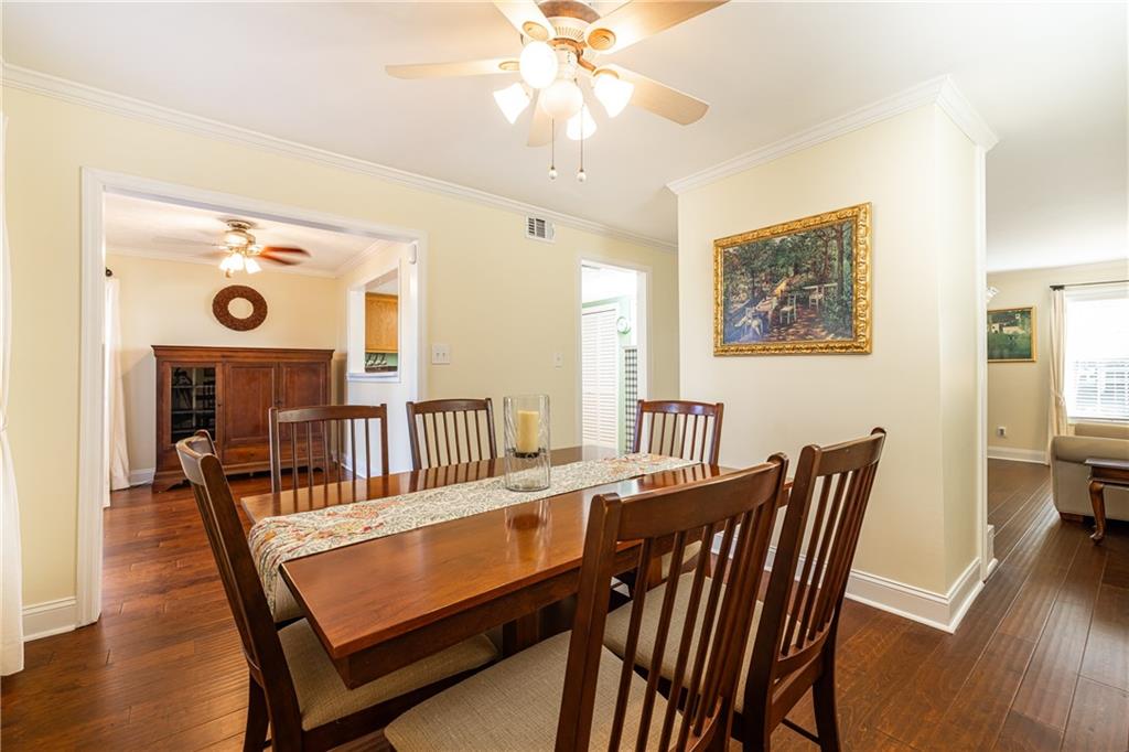 7750 Roswell Road, Unit 9G Sandy Springs, GA 30350 - Photo 4 of 18 a view of a dining room with furniture and wooden floor
