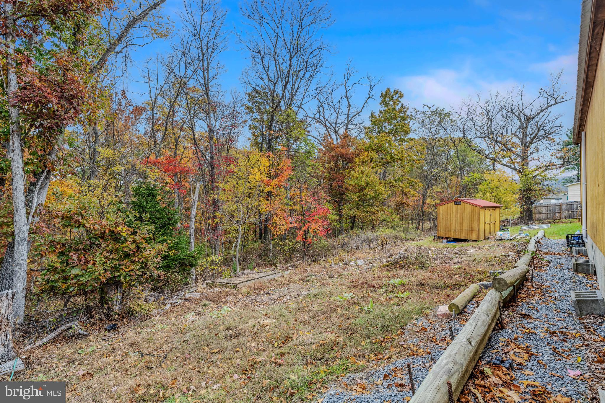 393 Ridersville Road Berkeley Springs, WV 25411 - Photo 14 of 32 a view of a backyard with wooden fence