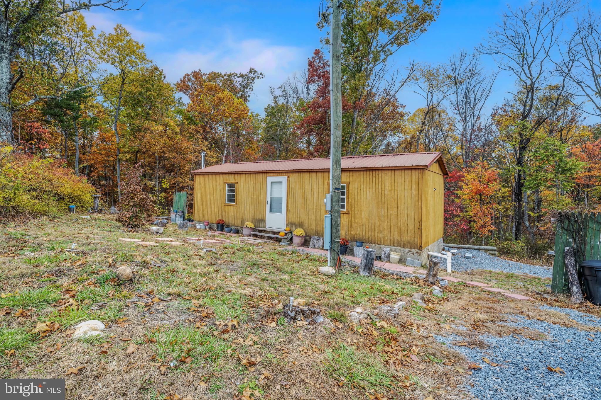 393 Ridersville Road Berkeley Springs, WV 25411 - Photo 2 of 32 a view of a house with backyard and trees