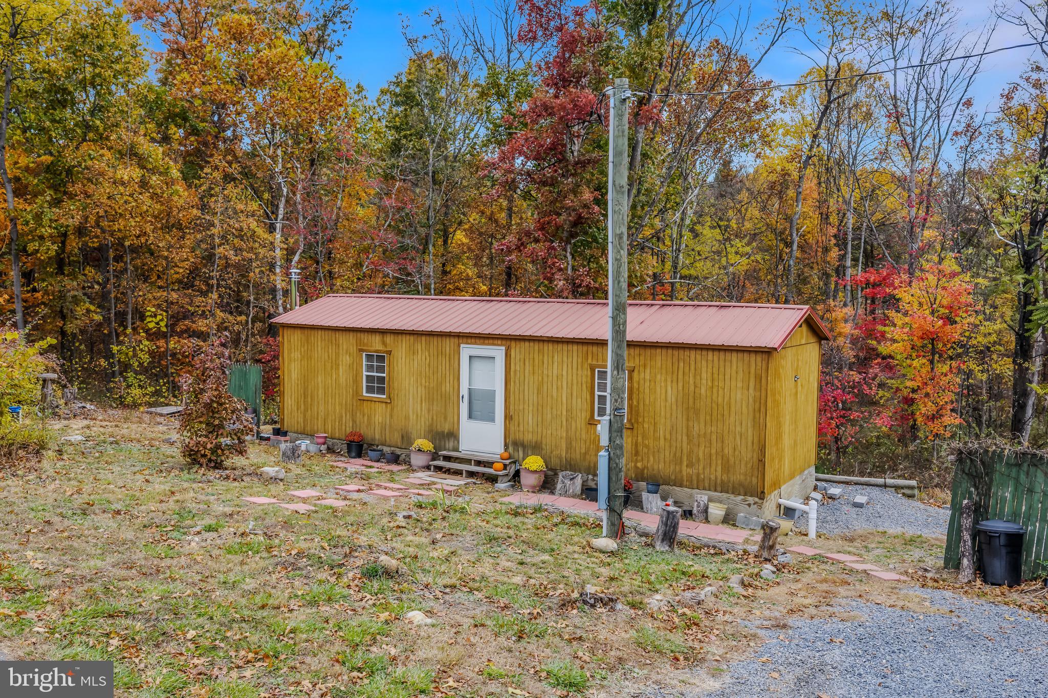 393 Ridersville Road Berkeley Springs, WV 25411 - Photo 3 of 32 a view of a house with backyard and sitting area