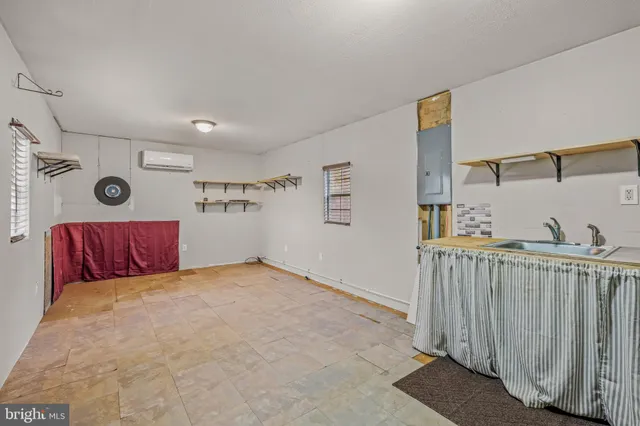 a view of a bedroom with wooden floor