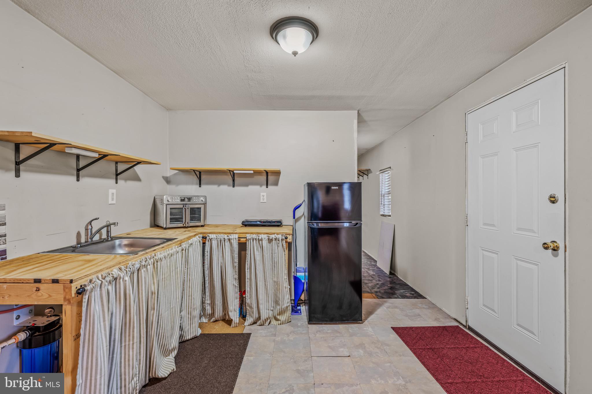 393 Ridersville Road Berkeley Springs, WV 25411 - Photo 6 of 32 a view of a storage & utility room with two washing machine