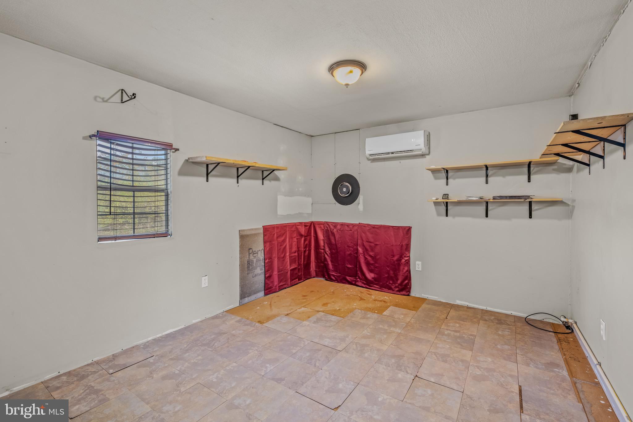 393 Ridersville Road Berkeley Springs, WV 25411 - Photo 7 of 32 a bedroom with a bed and the view of kitchen