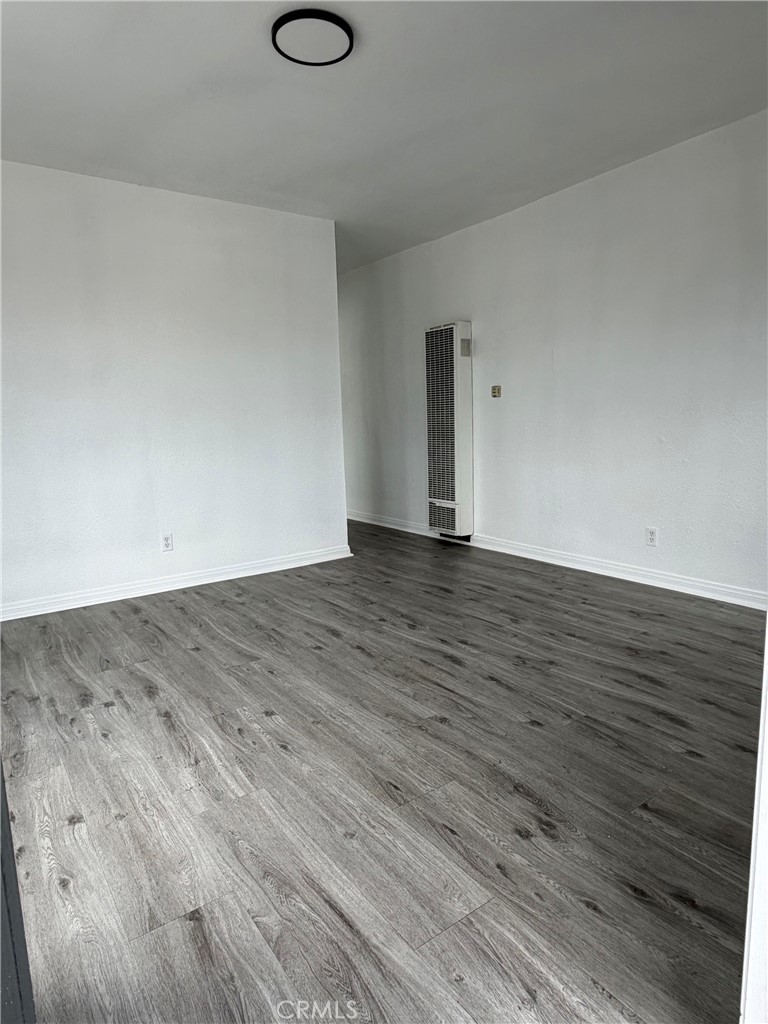 304 West Cedar Street Compton, CA 90220 - Photo 9 of 9 a view of an empty room with wooden floor and a window